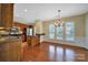 Kitchen and breakfast area with hardwood floors, stainless steel appliances, and island seating at 9020 Smokey Hill Ln, Fort Mill, SC 29707