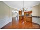 Open-concept kitchen and dining area with hardwood floors, stainless steel appliances, and granite countertops at 9020 Smokey Hill Ln, Fort Mill, SC 29707