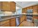Updated kitchen offers granite countertops, stainless appliances, tile backsplash, and wooden cabinetry at 9020 Smokey Hill Ln, Fort Mill, SC 29707