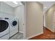 Convenient laundry room featuring tile flooring, wire shelving, and modern washer and dryer at 9020 Smokey Hill Ln, Fort Mill, SC 29707