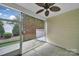 Screened patio featuring a ceiling fan, screened walls, and an outdoor view at 9020 Smokey Hill Ln, Fort Mill, SC 29707