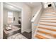 Hallway showing staircase leading to office with dark floors, neutral paint and a large window at 925 Westbrook Dr # B, Charlotte, NC 28202