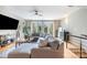 Spacious living room with hardwood floors, featuring a gray sectional sofa and french doors leading to a balcony at 925 Westbrook Dr # B, Charlotte, NC 28202