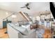 Open concept living room showing hardwood floors, a large sectional sofa and a view into the kitchen and staircase at 925 Westbrook Dr # B, Charlotte, NC 28202