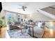 Bright living room boasting hardwood floors, a ceiling fan, a large sectional sofa, and access to an outdoor balcony at 925 Westbrook Dr # B, Charlotte, NC 28202