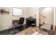 Home office with desk, piano, and a large rug, next to a staircase at 925 Westbrook Dr # B, Charlotte, NC 28202