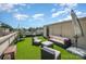Relaxing rooftop patio showcasing modern furniture, including hanging chairs and an umbrella for shade at 925 Westbrook Dr # B, Charlotte, NC 28202