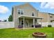 Large backyard featuring a covered patio, grill, fire pit and privacy fence at 9733 Paper Tree Rd, Charlotte, NC 28227