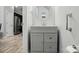 Powder room featuring modern vanity with sink and gray cabinets at 9733 Paper Tree Rd, Charlotte, NC 28227