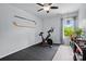 Bright bedroom with a peloton, sports memorabilia, and a window at 9733 Paper Tree Rd, Charlotte, NC 28227