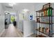 Bright hallway with wood-look flooring, shelving, and views into other rooms at 9733 Paper Tree Rd, Charlotte, NC 28227