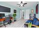 Comfortable home office with hardwood floors, ceiling fan, couch, and large monitor on a desk at 9733 Paper Tree Rd, Charlotte, NC 28227