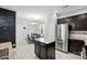 Kitchen and dining area featuring stainless steel appliances, a kitchen island, and dark wood cabinets at 9733 Paper Tree Rd, Charlotte, NC 28227