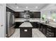 Kitchen featuring granite countertops, stainless steel appliances, a kitchen island, and dark wood cabinets at 9733 Paper Tree Rd, Charlotte, NC 28227