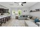 Open-concept living room featuring a comfortable gray sectional sofa, stylish rug, and plenty of natural light at 9733 Paper Tree Rd, Charlotte, NC 28227