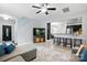 Open-concept living room next to the kitchen featuring barstool seating, light floors, and a comfortable sectional at 9733 Paper Tree Rd, Charlotte, NC 28227