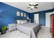 This main bedroom boasts blue walls and a gray bed beneath a ceiling fan at 9733 Paper Tree Rd, Charlotte, NC 28227