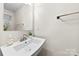 Modern half bathroom featuring a white sink and minimalist design at 1022 Hinson Forest Rd, Monroe, NC 28110