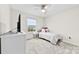 Bright bedroom with a ceiling fan, large window, and plush carpeted floor at 1022 Hinson Forest Rd, Monroe, NC 28110