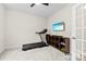 Bedroom with a treadmill, TV, and storage unit, creating a functional workout space at 1022 Hinson Forest Rd, Monroe, NC 28110