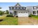 Charming two-story home features a manicured lawn and a two-car garage at 1022 Hinson Forest Rd, Monroe, NC 28110