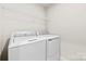 Well-lit laundry room equipped with modern washing machines at 1022 Hinson Forest Rd, Monroe, NC 28110