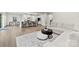 Open concept living room with modern furniture, hardwood flooring, and views to the kitchen at 1022 Hinson Forest Rd, Monroe, NC 28110