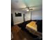 Well-lit bedroom features hardwood floors, a wall-mounted television, and minimalist décor for a modern aesthetic at 110 Buffalo Nw Ave, Concord, NC 28025