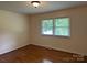 Cozy bedroom with hardwood floors and natural light from a large window for a comfortable space at 1115 Dumbarton Rd, Gastonia, NC 28054