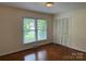 A bright bedroom with hardwood floors, closet space, and a large window bringing in natural light at 1115 Dumbarton Rd, Gastonia, NC 28054
