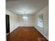 Elegant dining room featuring hardwood floors, wainscoting, and a classic chandelier at 1115 Dumbarton Rd, Gastonia, NC 28054