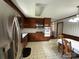 Eat-in kitchen boasting dark wood cabinetry and stainless steel appliances, perfect for Gathering meals at 1115 Dumbarton Rd, Gastonia, NC 28054