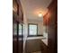 Functional laundry room with washer, dryer, and built-in cabinetry for organized storage at 1115 Dumbarton Rd, Gastonia, NC 28054