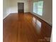 Spacious living room showcasing gleaming hardwood floors and sunlit windows, creating a warm ambiance at 1115 Dumbarton Rd, Gastonia, NC 28054