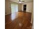 Bright living room featuring hardwood floors, a ceiling fan, and access to the kitchen at 1115 Dumbarton Rd, Gastonia, NC 28054