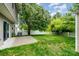 Spacious backyard with lush greenery, mature trees, and white fence at 116 Amber Woods Dr, Tega Cay, SC 29708