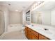 Bathroom with double sink vanity, soaking tub, and separate glass-enclosed shower stall at 116 Amber Woods Dr, Tega Cay, SC 29708
