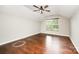 Cozy bedroom featuring hardwood floors, a ceiling fan, and a window with a view at 116 Amber Woods Dr, Tega Cay, SC 29708