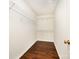 Walk-in closet with hardwood floors and white shelving at 116 Amber Woods Dr, Tega Cay, SC 29708