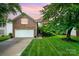 Charming two-story brick home with a well-manicured lawn and attached two-car garage at 116 Amber Woods Dr, Tega Cay, SC 29708