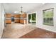 Bright eat-in kitchen with wooden cabinets, stainless appliances, and sliding glass doors to the patio at 116 Amber Woods Dr, Tega Cay, SC 29708