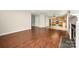 Open-concept living room with hardwood floors flowing into the adjacent kitchen with appliances at 116 Amber Woods Dr, Tega Cay, SC 29708