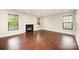 Bright living room featuring hardwood floors, a fireplace, and large windows for natural light at 116 Amber Woods Dr, Tega Cay, SC 29708