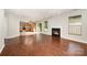 Open-concept living room featuring hardwood floors, a fireplace, and connection to the kitchen at 116 Amber Woods Dr, Tega Cay, SC 29708