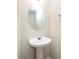 A clean powder room features a pedestal sink with an oval mirror and chrome fixtures at 116 Amber Woods Dr, Tega Cay, SC 29708