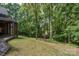 Backyard featuring a lush green lawn surrounded by mature trees at 118 Tayport Dr, Troutman, NC 28166
