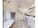 This luxurious bathroom features patterned floors, a soaking tub, separate shower, and double vanity at 118 Tayport Dr, Troutman, NC 28166