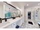 Modern bathroom with patterned floors, glass shower, double vanity, and view to walk in closet at 118 Tayport Dr, Troutman, NC 28166