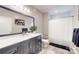 Bathroom showcasing navy vanity with quartz countertop, modern fixtures, and neutral walls at 118 Tayport Dr, Troutman, NC 28166