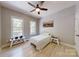 Bedroom features light wood flooring and lots of natural light from the bright windows at 118 Tayport Dr, Troutman, NC 28166